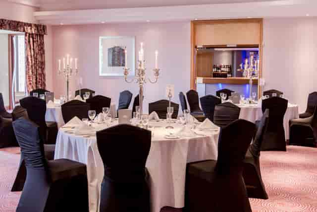 Grand Ballroom at Stormont Hotel with banquet tables, perfect for wedding and gala event venues.