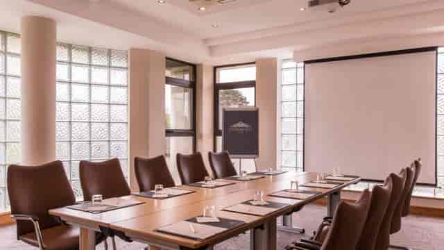 Dunmisk Suite boardroom with leather chairs, ideal for professional corporate meetings and events.
