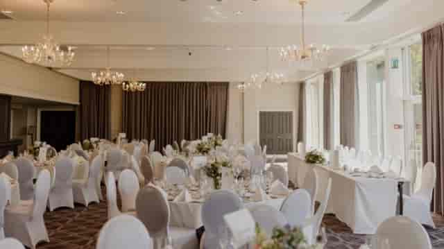 Ardoe House ballroom with elegant chandeliers for a wedding or gala event.