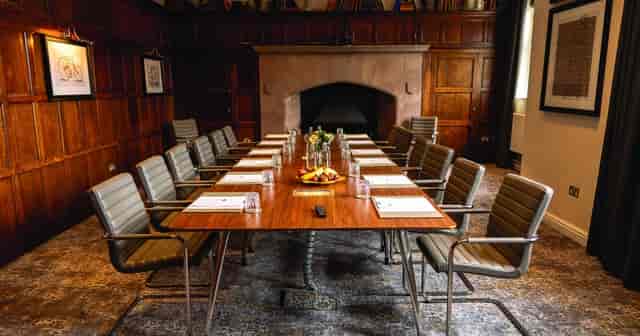 Executive boardroom at De Vere Cranage Estate with wood paneling for corporate strategy meetings.