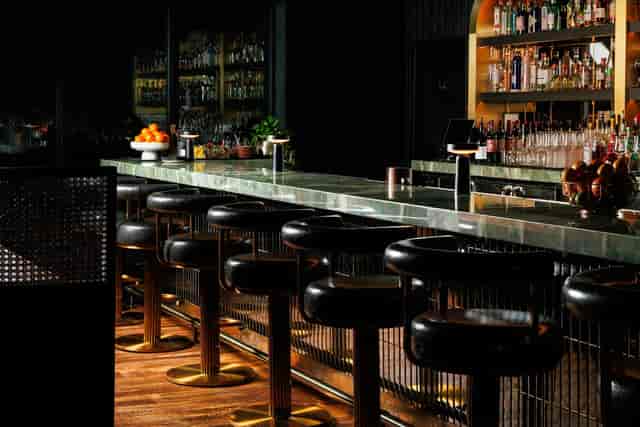 Upscale stone bar at Realm Rooftop for executive cocktail hours and networking events.