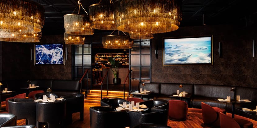 Private dining room at Realm Rooftop Bar with statement lighting for VIP corporate events.