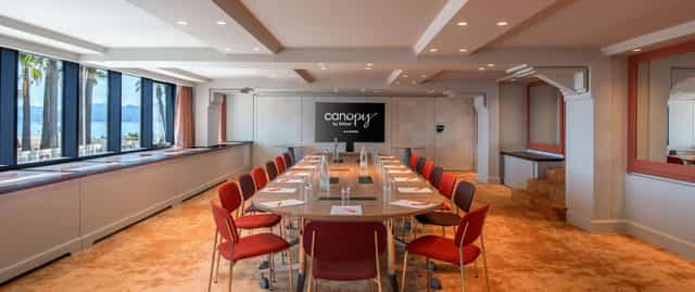 Modern boardroom in Canopy by Hilton Cannes featuring contrast seating for corporate meetings.