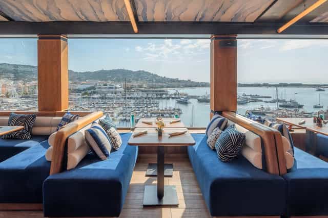 Canopy by Hilton Cannes retreat room: luxury harbor view venue for corporate networking events.