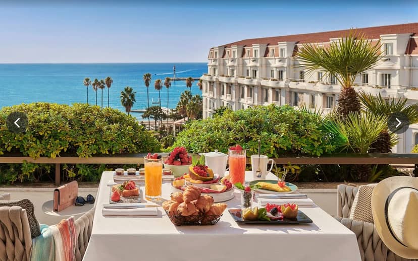 Luxury outdoor breakfast terrace at Hotel Barrière Le Gray d'Albion for VIP executive retreats.