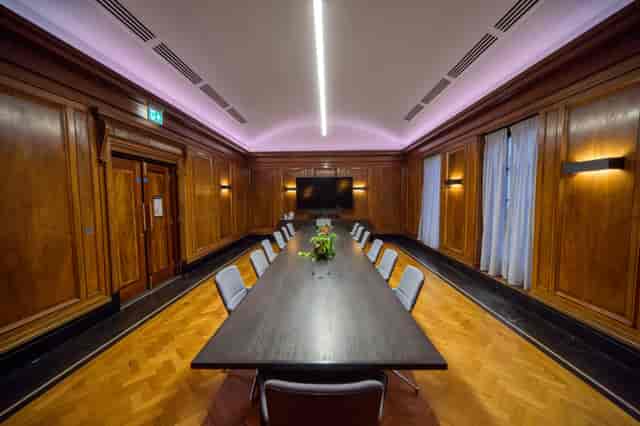 Executive boardroom with wood paneling for professional meetings and corporate events.
