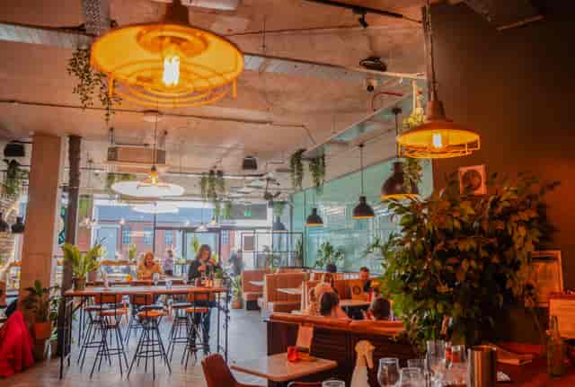 Industrial-chic BOXPARK Liverpool venue with varied seating for workshops and networking events.