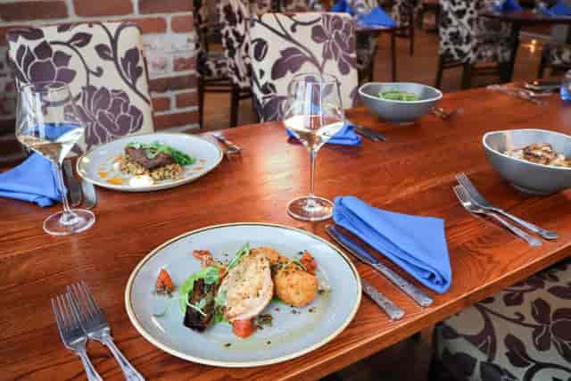 Rustic Stable Inn event space with blue linens for executive dinners and networking meals.