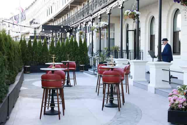 Private terrace for upscale cocktail reception at Dover Marina Hotel with ambient string lighting.
