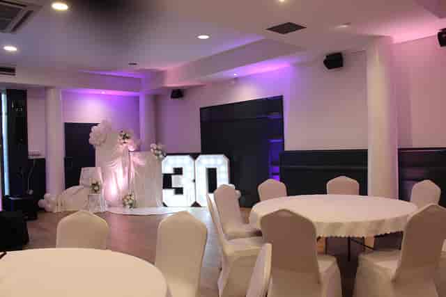 Milestone birthday banquet setup at Phibsborough Community Centre with illuminated marquee signs.