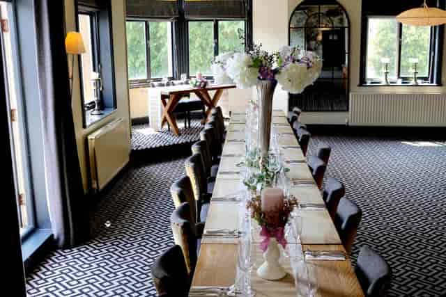 Private dining room at The Kings Head with linear table for board dinners and celebrations.