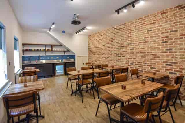 Industrial-chic meeting room and courtyard for collaborative workshops and corporate networking.