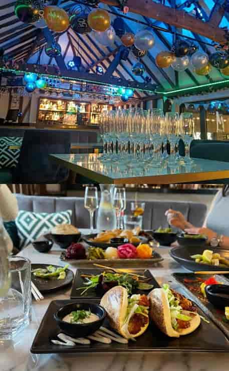 Upstairs at The M Bar: Glassware setup for an elegant welcome reception and communal dining event.
