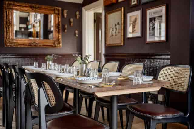 Sophisticated private dining room with cane-back seating for VIP dinners and corporate events.