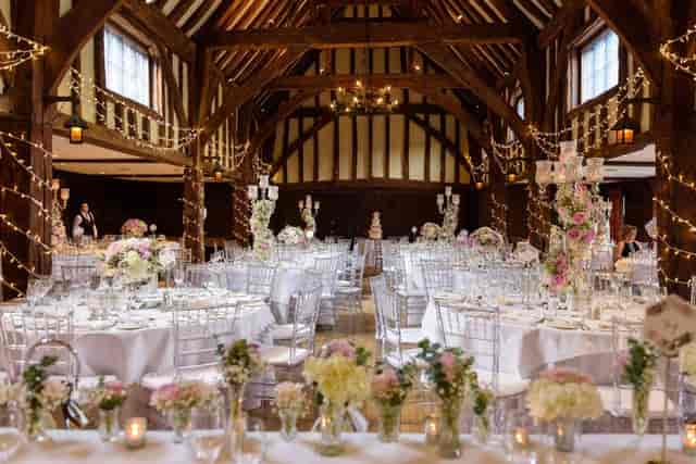 Rustic wedding function room with timber beams, elegant table settings, and event space.