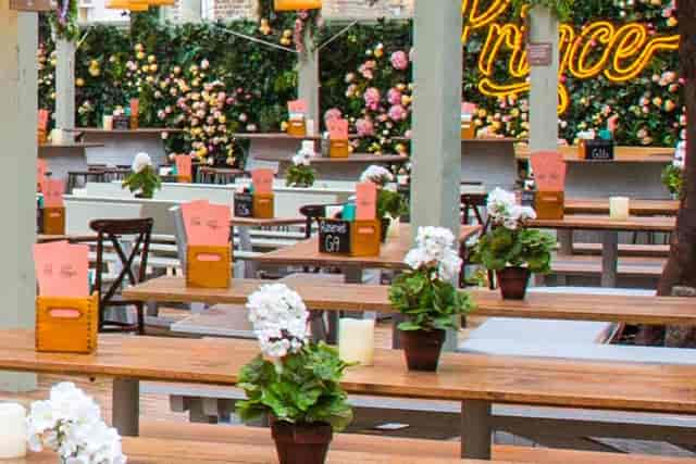 Garden Pergola at The Prince Albert with floral walls and bench seating for events and parties.