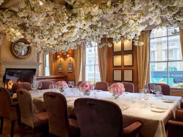 Private dining room at Clos Maggiore with floral ceiling, ideal for luxury board dinners or events.