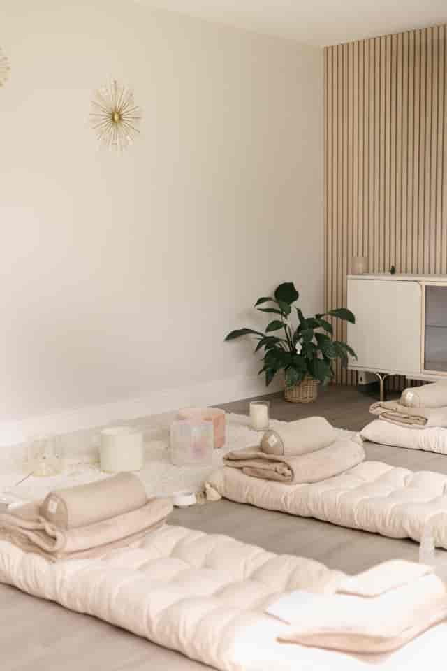 Minimalist Nurture Room with sound bowls for corporate wellness retreats and mindfulness sessions.