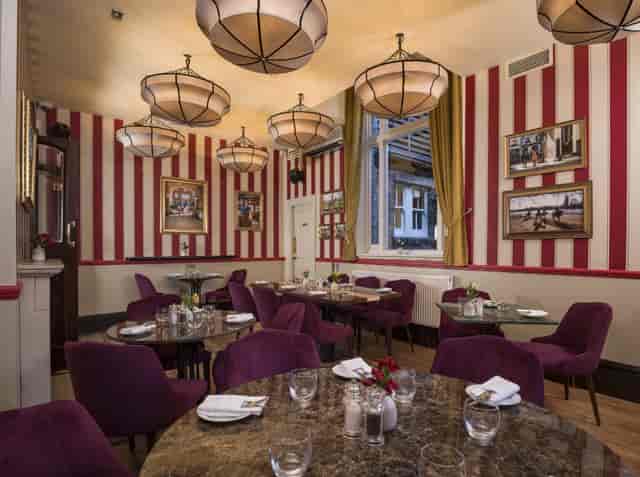 The Stablehand private dining room with purple velvet seating for executive meetings and networking.