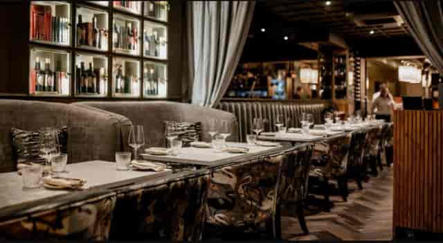 Sophisticated restaurant venue for corporate dinners and networking events with banquette seating.