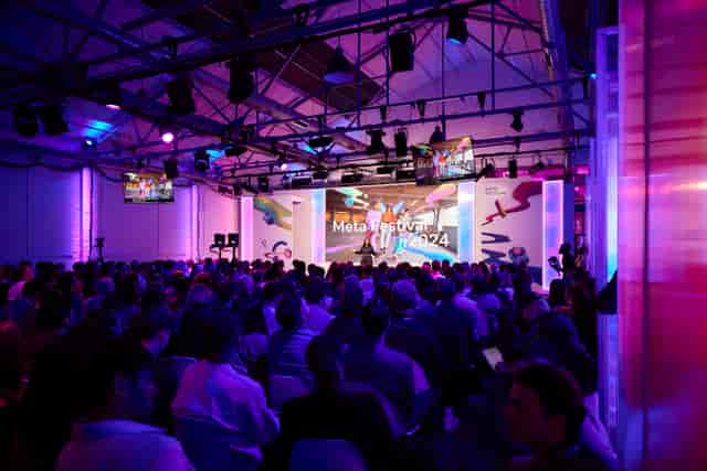 Meta Festival keynote at Protein Studios featuring industrial-chic venue and professional AV setup.