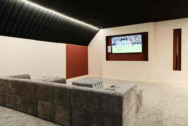 Gladiator Suite: Modular lounge seating for corporate breakout sessions and private event screenings.