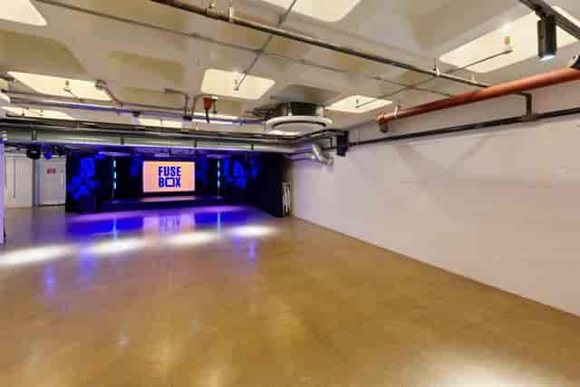 FUSEBOX Kingston industrial venue with stage for product launches and creative workshops.