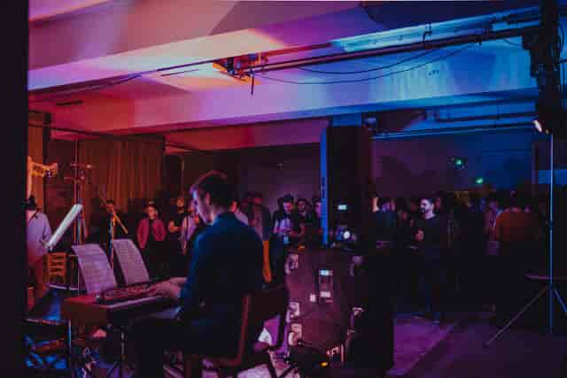 Industrial-chic networking reception with live acoustic music at Civic House, Agile City venue.