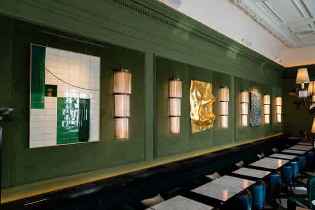 Aki London main dining room with sage velvet panels for upscale private dining and networking.