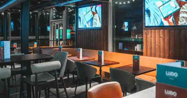 Ludo Sports & Live Lounge Exeter: Modern venue with AV screens for corporate networking events.