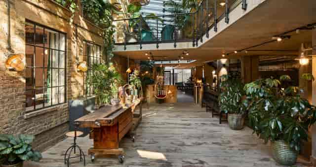 Industrial-chic London Fields workshop venue with biophilic design for networking and events.