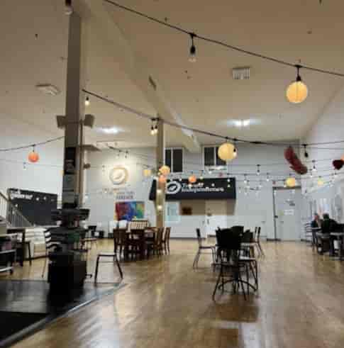 Small Hall at Woodman Community Centre with string lighting, ideal for social mixer and workshop.