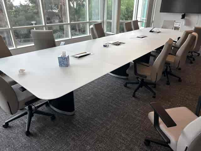 The Trophy Room boardroom: messy post-meeting state for event planning and venue management.