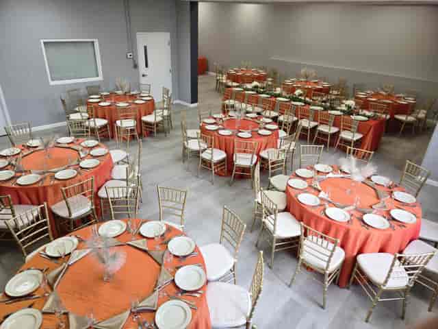 Upstairs event space at The Veg Box Cafe, banquet setup with orange linens for parties and weddings.