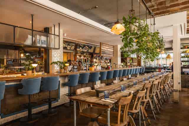 Spacious bar and seating at The Stables Riding House Café for networking and corporate events