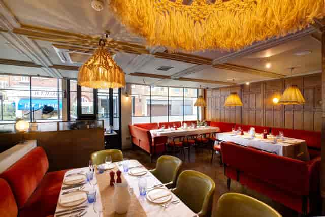 Semi-private dining room with booth seating, ideal for corporate dinners and networking events.
