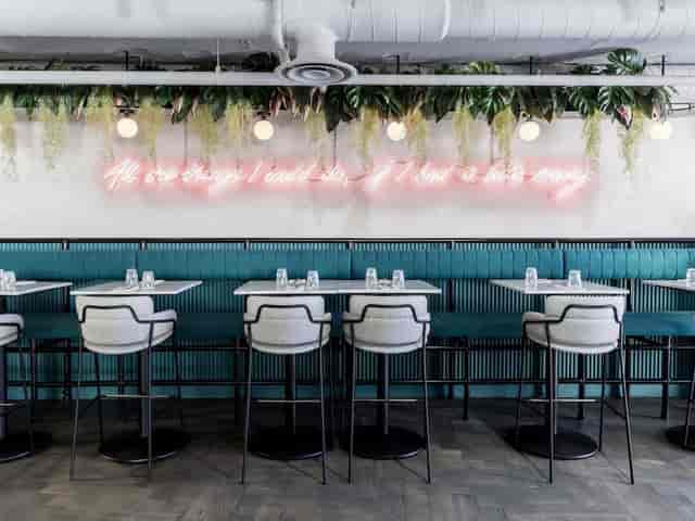 Modern Grind Shoreditch venue with neon lighting, perfect for creative workshops and networking.