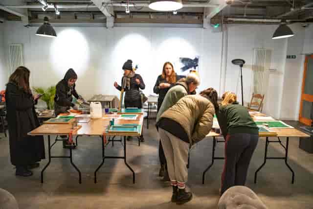 Industrial cafe workshop space with modular tables for collaborative events and creative sessions.