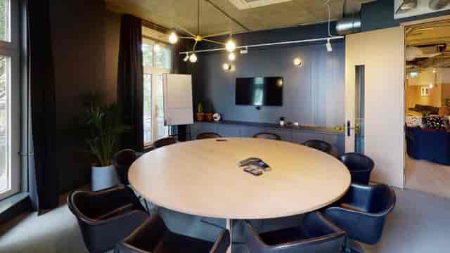 Modern boardroom with round table for strategy meetings and corporate workshops.