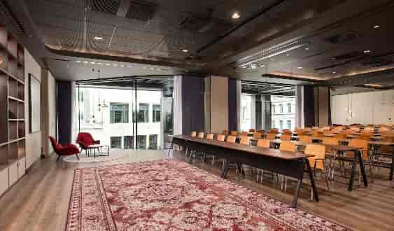 Classroom-style meeting room with breakout nook for executive training and strategic planning.
