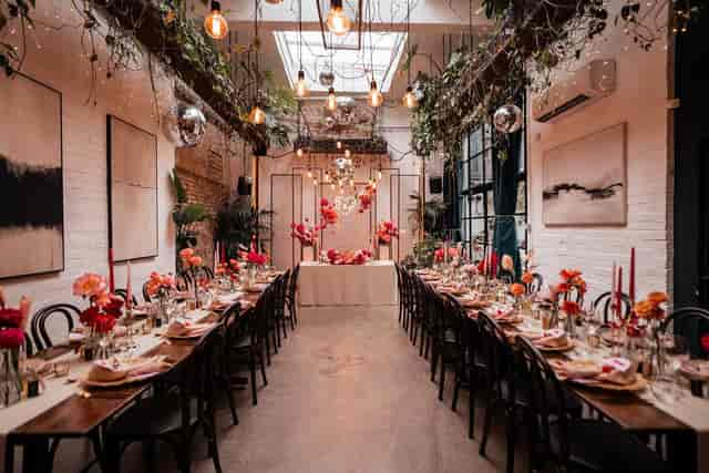 Industrial Garden Room event space with floral decor for boutique weddings and corporate dinners.