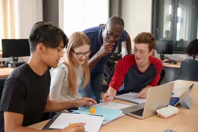 Small-group breakout session at Plaistow Classroom, London exam centre.