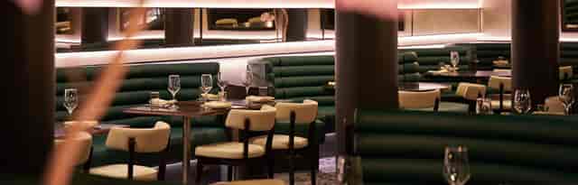 The Astrea restaurant with plush banquettes, ideal for VIP networking and corporate dinners.