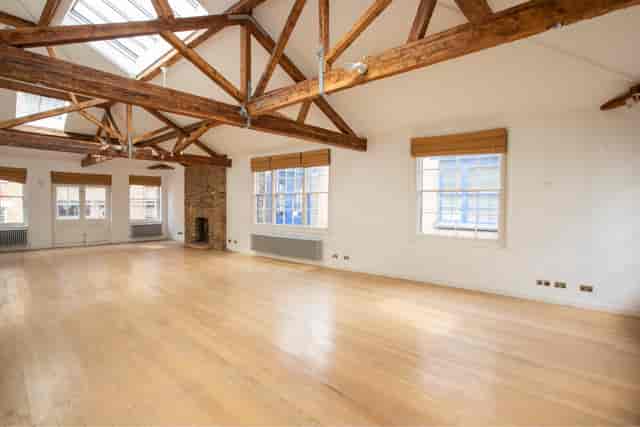 Shoreditch Loft event venue with timber trusses for art exhibitions and private receptions.