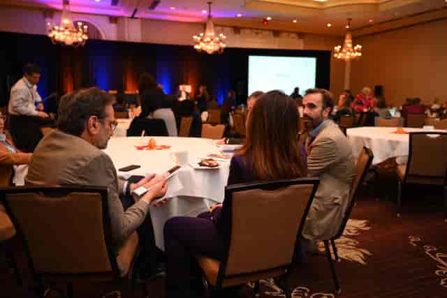 Main Hall ballroom with round tables for professional networking and breakout events.