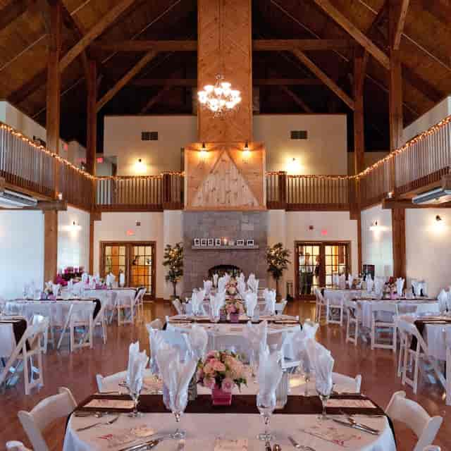 Rustic-chic event venue with stone fireplace for weddings and corporate retreats.