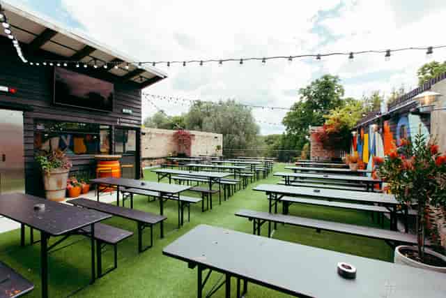 The Banyard Room outdoor space with string lighting for networking events and team building.
