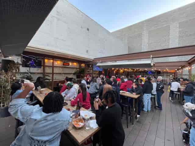 Networking event at The Portland Arms courtyard featuring communal tables for casual gatherings.