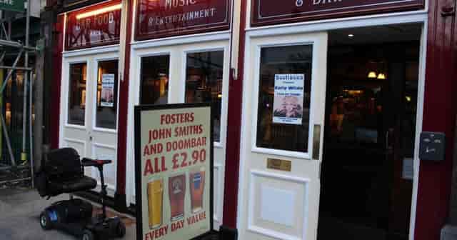Main Pub venue with exterior pricing signage, ideal for casual social mixers and event hosting.