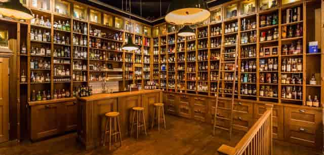 Room 1 at TT Liquor: Luxury event venue with iconic whiskey shelving for VIP receptions.
